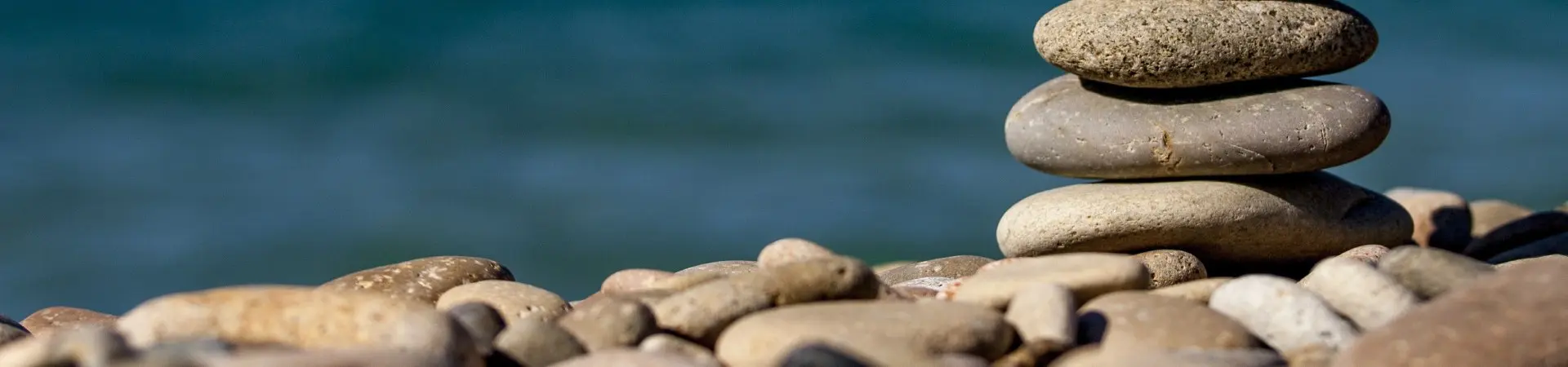 A close up of some rocks on the beach